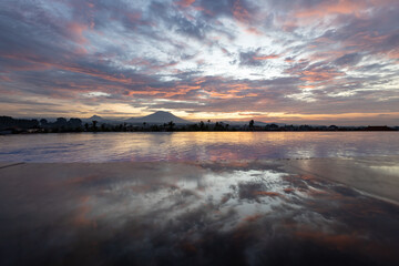 Wall Mural - The sky is a beautiful mix of pink and orange hues, creating a serene