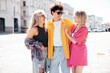 © halayalex - Group of young three stylish friends posing in the street. Fashion man and two cute female dressed in casual summer clothes. Smiling models having fun in sunglasses. Cheerful women and guy outdoors