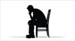 © nanda - Silhouette of a pensive man sitting on a chair, deep in thought
