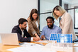 © PINA - team of multiethnic coworker meeting on solar roof system project with solar panel house model, responsibility of green industry alternative renewable clean environment energy for sustainable business