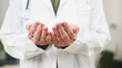 © Meeko Media - Compassionate Doctor In White Coat Offering Caring Hands In Medical Setting