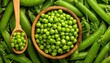 © zerogami - Freshly harvested green peas in a wooden bowl and spoon top view.
