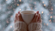 © Jirawatfoto - Woman hand holding cozy mug of warm coffee in white sweater. peaceful winter morning with snow falling outside during christmas season. Feeling of comfort
