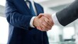 © ryker - Business handshake between two professionals in suit conveying agreement and trust during corporate meeting