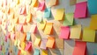 © Broles - A textured wall is covered in a vibrant array of sticky notes. The notes are in various colors, arranged at different angles