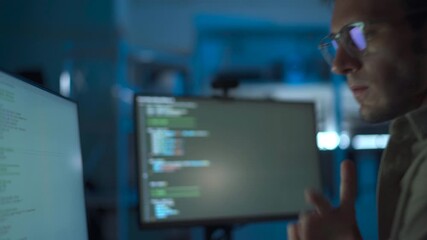 Nighttime programmer working with focus in his tech workspace.