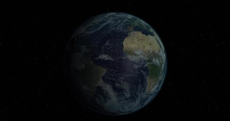 Wall Mural - Floating blue planet Earth rotating slowly in vacuum of outer space, with distant stars