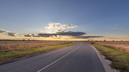 Wall Mural - Long road with a clear blue sky in the background