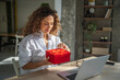 © Miljan Živković - Woman receiving online gift during video call