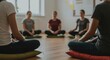 © Sandor - diverse group of young adults meditating together in a peaceful yoga class setting