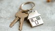 © Nami - Keys with house shaped keyring against a textured surface background