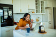 © Geber86 - Young woman going over her bills and finances at home