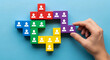 © Riski Digital Studio - Team building with colorful blocks and person icons, strategic puzzle piece