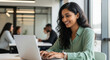 © PRASANNAPIX - Happy Indian Businesswoman Working on Laptop in Modern Office