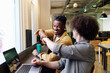 © BusinessClass by W61 - Smiling business colleagues giving fist bump at workplace