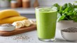 © Sam-th - Refreshing Green Smoothie with Banana and Spinach on a Kitchen Countertop in Bright Atmosphere
