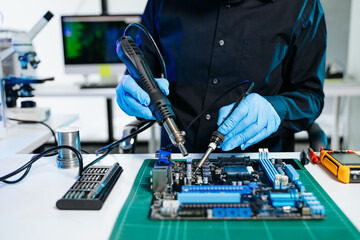 The technician repairing the motherboard in the lab with copy space. the concept of computer hardware, mobile phone, electronic, repairing, upgrade