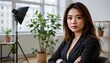© wannakorn - Confident Businesswoman Posing in Stylish Indoor Workspace with Natural Light and Greenery