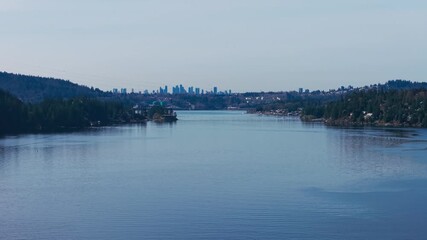 Wall Mural - A scenic aerial drone shot of the Indian arm river with a view of Burnaby over the horizon