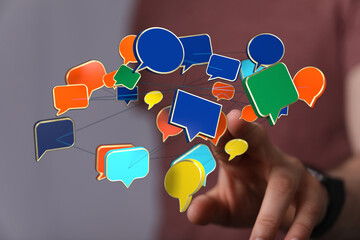 Wall Mural - Concept of communication with speech bubbles floating around a finger, symbolizing interaction and social media. Communication concept.
