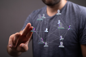 Wall Mural - Person's hand touches network of people in abstract hologram. Digital network connection concept. Representing networking, connection and techno