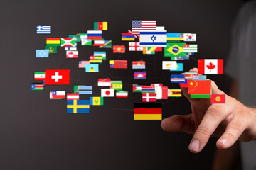 Wall Mural - A person interacting with world flags, representing globalization, communication and international relationships. Concept of global digital conn