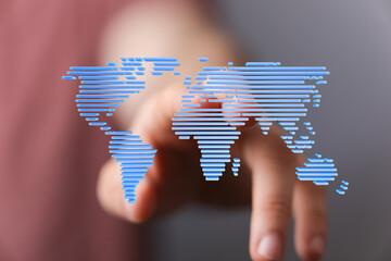 Wall Mural - Hand pointing at a digital world map, illustrating global connectivity and technology.