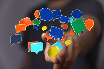 Wall Mural - Hand interacting with 3D speech bubbles illustrates digital dialogue, networking and communication in modern digital landscape and business tren