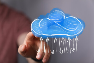 Wall Mural - Close-up of a hand touching a cloud with arrows, a concept of the cloud, data, or weather on a digital interface