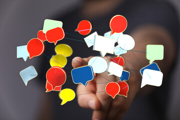 Wall Mural - Conceptual image representing online communication, networking, and sharing thoughts. Features colorful chat bubbles, hand, connection, global c