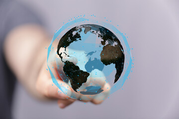 Wall Mural - Hand interacts with a digital earth, representing global connection and technology.