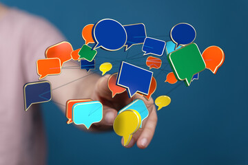 Wall Mural - Hand interacting with speech bubbles, social media communication and connection conceptual image, networking concept with speech symbols.