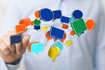Wall Mural - Digital hand touches colorful speech bubbles representing communication and connection in the virtual space. Future technology is here.