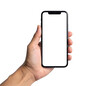 © Jeruk - A hand holds a black smartphone with a blank white screen against a black backdrop