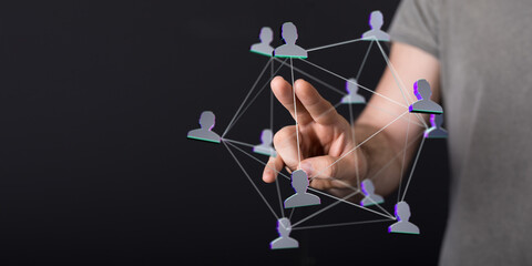 Wall Mural - A person's hand connecting with a network of digital representations symbolizing social connections, team work, and communication.