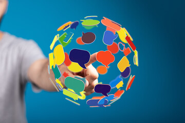 Wall Mural - Network of speech bubbles symbolizes communication and global interconnectedness in the digital age, with a person interacting with the concept.