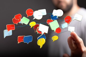 Wall Mural - Abstract image of a network of colorful speech bubbles connected with lines, suggesting communication and online dialogue. Hand touching the flo