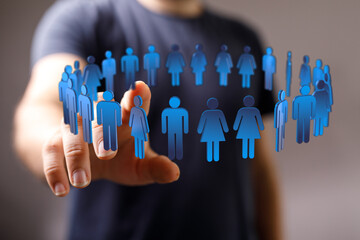 Wall Mural - A hand interacting with a digital representation of people arranged in a circle, teamwork, human resources, digital concept, online community, g