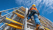 © angelmaxmixam - A construction worker wearing a hard hat and safety vest climbs tall scaffolding against a bright blue sky, showcasing diligence and safety at a building site.