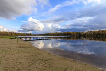 Wall Mural - Dock is visible on the shore of a lake