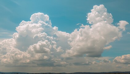 Wall Mural - Fluffy white clouds floating in a clear azure sky