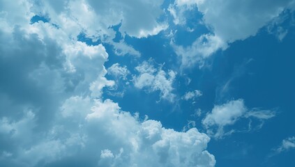 Wall Mural - Gorgeous azure sky dotted with billowy white clouds, offering a peaceful and scenic view.