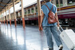 © PIC SNIPE - Happy Asian senior boarding a train at the station
