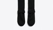 © VirtualVista - Dark colored thick fabric socks on a plain light surface