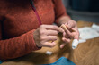 © Johnér - Close-up of woman's hand applying bandage on finger