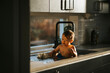 © Johnér - Shirtless boy sitting inside kitchen sink at home