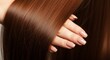 © detiyy - Woman touching long brown hair closeup
