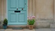 © Toto - A pastel turquoise door with pink tulips stands before a stone wall.