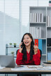 © Kritdanai - Cheerful Woman Talking on Phone in Home Office