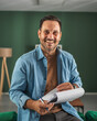 © Miljan Živković - Smiling man holding documents working home office